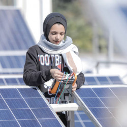 Young woman working with solar panels