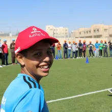 Boy on a sports field with other children