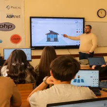 Teacher at board with classroom of students