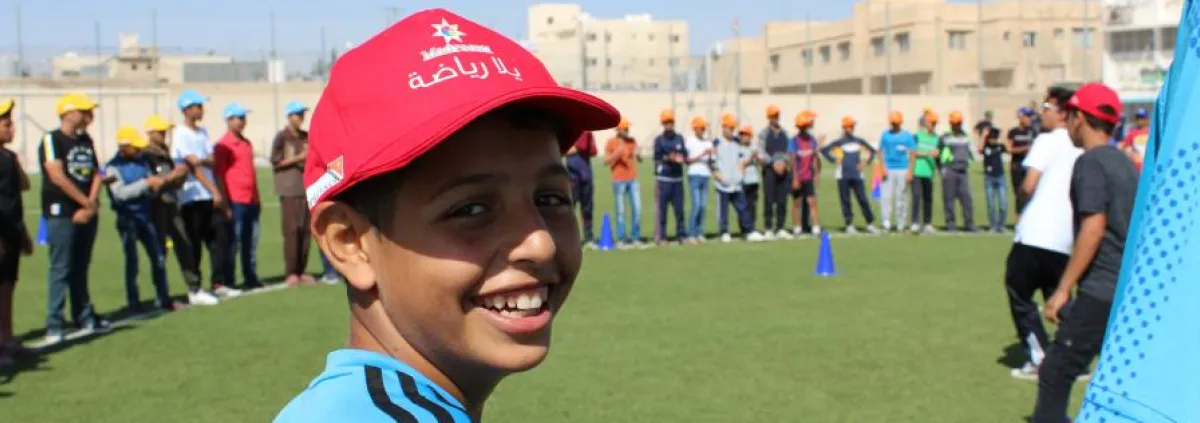 Boy on a sports field with other children